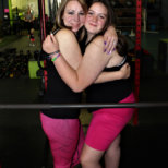 side of black and pink leggings with black tank and pink XL shorts