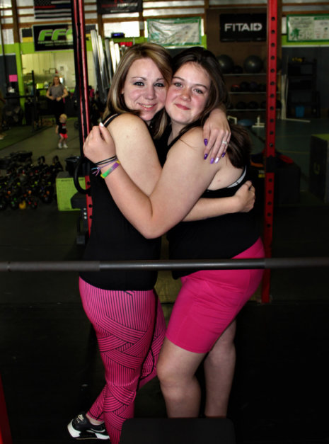 side of black and pink leggings with black tank and pink XL shorts